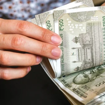 Rupee hits multi-week high as falling oil prices boost market sentiment